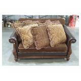 Loveseat. Rolled arms and wood accents. Finish