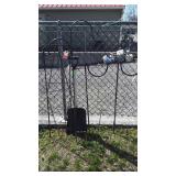 Group of outdoor flower pot hangers and a shovel