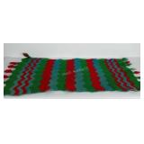 Handmade throw rug. Measures approximately 24x50.