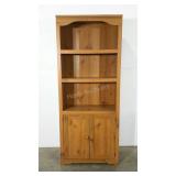 Storage cabinet. Open shelving over double door.