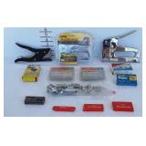 Three staple guns with staples of various sizes