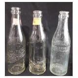 Three glass soda bottles, all marked Winchester,