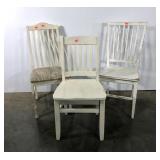 Three mis-matched white dining chairs