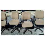 Four desk chairs on wheels. Matching fabric.