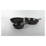 Three cast iron skillets, one 10.5", two marked