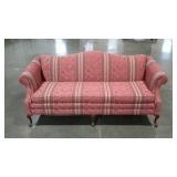 Camelback sofa in striped floral pattern. Rolled