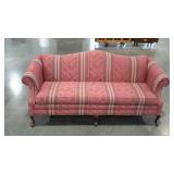 Camelback sofa in striped floral pattern. Rolled