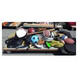 Skid with sports equipment helmets, balls,