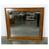 Large wood framed mirror with beveled glass.