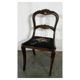 Single carved chair with needlepoint seat.  Some