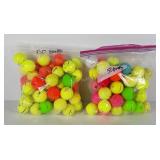 Two bags of used colored golf balls, 50 in each