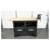 Workbench with metal base and thick wood top.