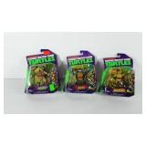 Three teenage mutant ninja turtle action figures,