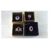 Four costume rings, sizes 6, 7.5, 7, and 7.5 with