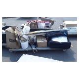 Skid of metal ironing board and iron, suitcase,