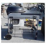 Weber charcoal grill with performer stand and