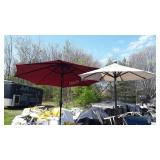 Two umbrellas with stands, one is missing thumb