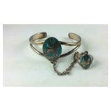 Silver tone bracelet with attached ring