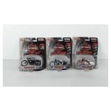 Three Harley Davidson die-cast replicas in boxes,