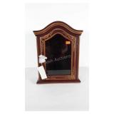 Table top display cabinet with door. Has pegs to