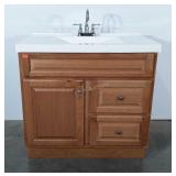 Oak finish bathroom vanity with rectangular sink,