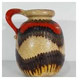 11" tall stoneware jug with handle. Marked West