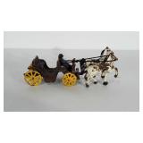 Cast iron horses and buggy. Measures 10" long.