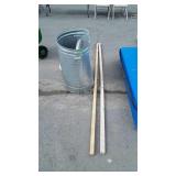 Beat up galvanized Trash can with lid, 2 sticks
