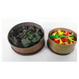 Two cookie tins full of army men