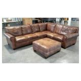 Leather sectional sofa with matching ottoman .