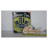 Two metal Chevrolet advertising signs, bent as