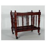 Wooden magazine / media rack on metal casters.