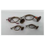 Four brass bugle horns, sizes vary