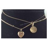 Two necklaces one with engraved heart pendant and
