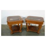 Pair of end tables with inlay design. Glass tops