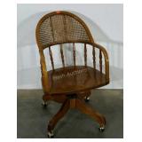 Office chair on casters, features a caned back,