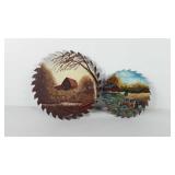 Two painted circular saw blades, artist signed,