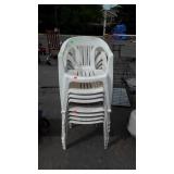 Stack of eight plastic lawn chairs
