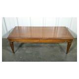 Burl wood coffee table in metal wheels. Has a few