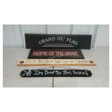 Four wooden wall plaques.