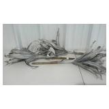 Three stalks of faux corn shuck, grey in color.
