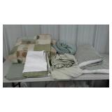 Assorted bedding in a variety of greens. Sheets,