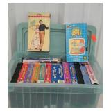 Small tote with lid full of VHS tapes. Musicals