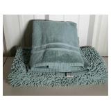 Two sage green bath towels and a sage green