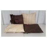Four throw pillows in assorted styles. All in
