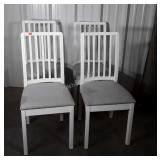 Group of four white dinning chairs