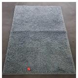 Blue shag rug is 4 feet long by 32" wide