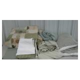 Assorted bedding in a variety of greens. Sheets,