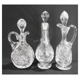 Three glass cruets, 9"-10"