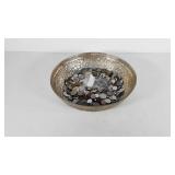 Bowl of foreign currency coins